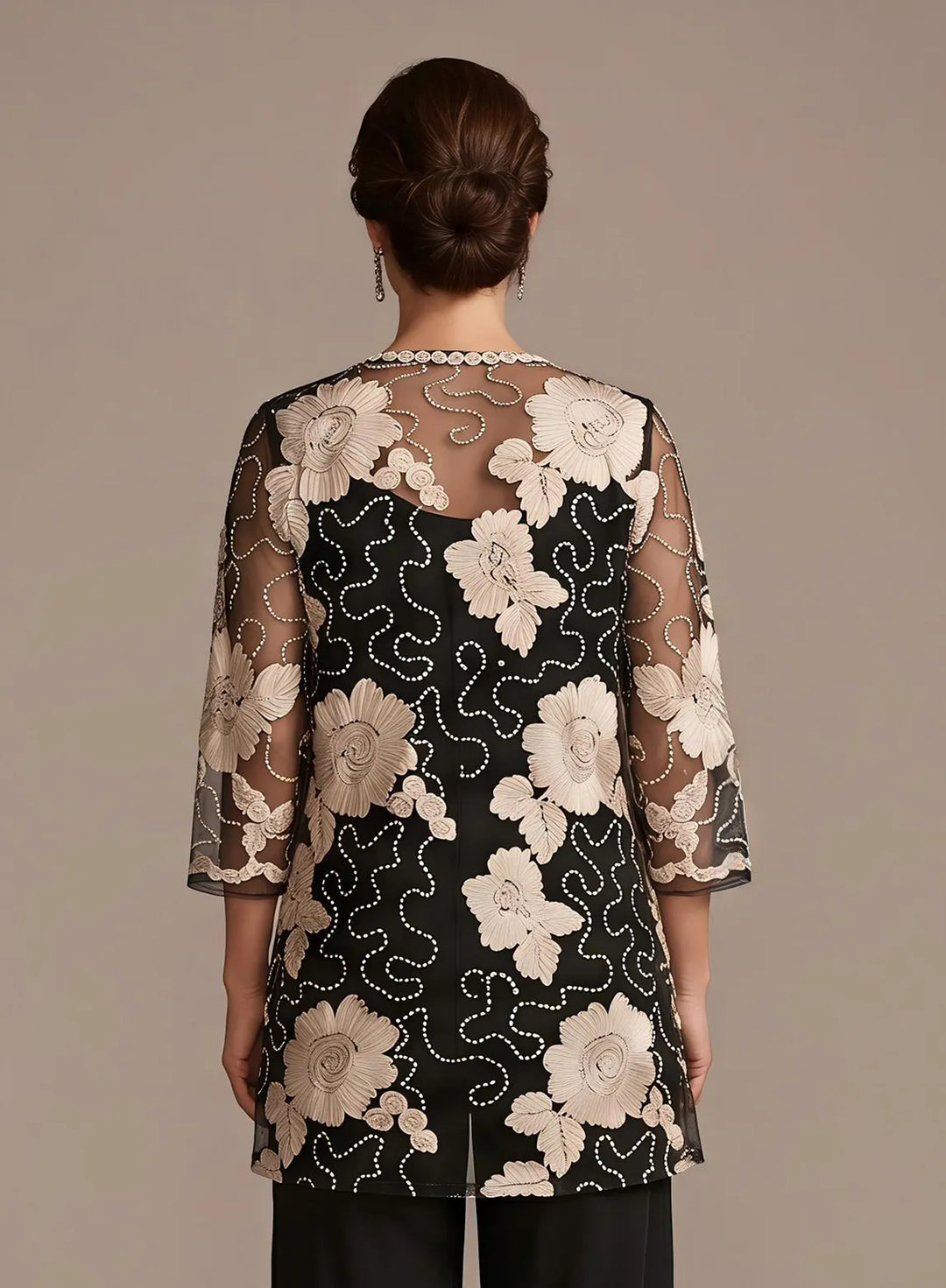 Black evening outfit with embroidered lace jacket and elegant flowing pants