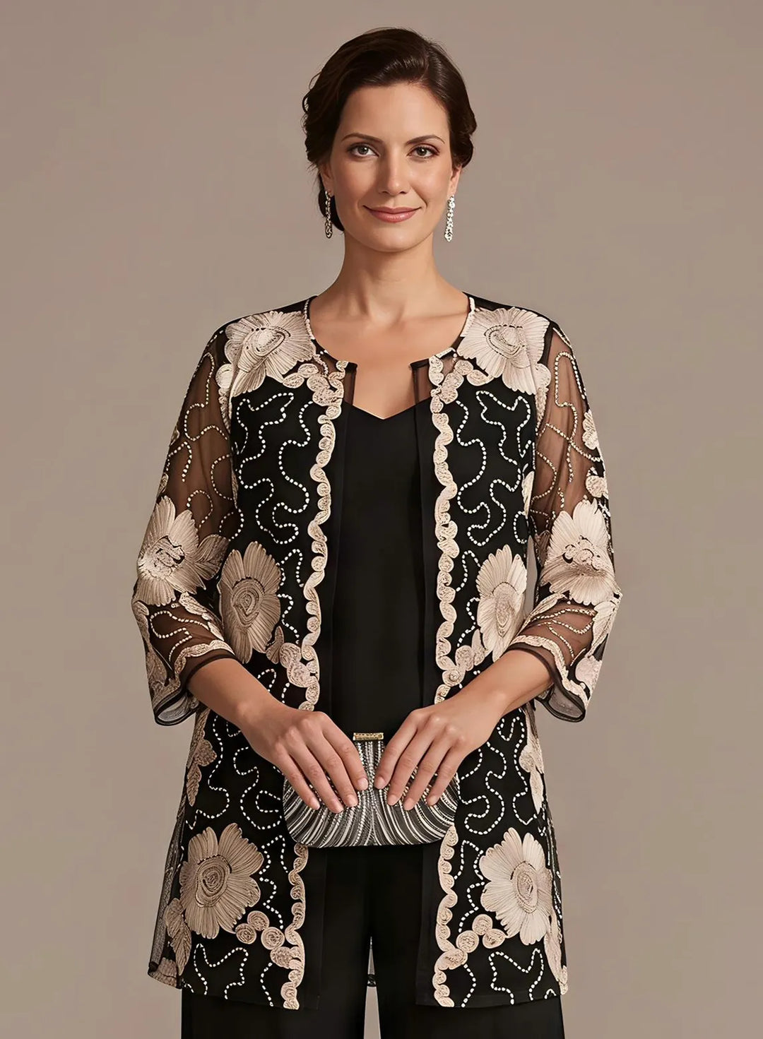 Black formal pantsuit featuring floral embroidered lace details and a refined evening look