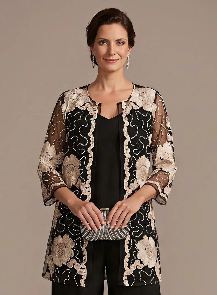 Black formal pantsuit featuring floral embroidered lace details and a refined evening look