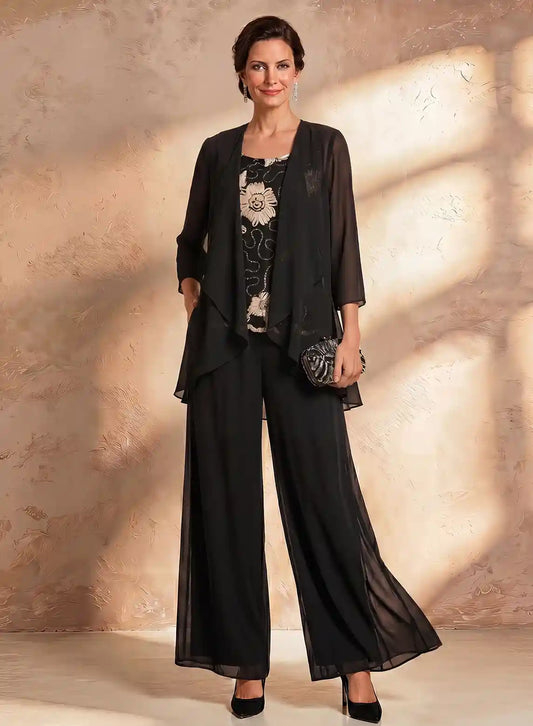 Elegant black wide leg wedding guest jumpsuit with floral lace top design