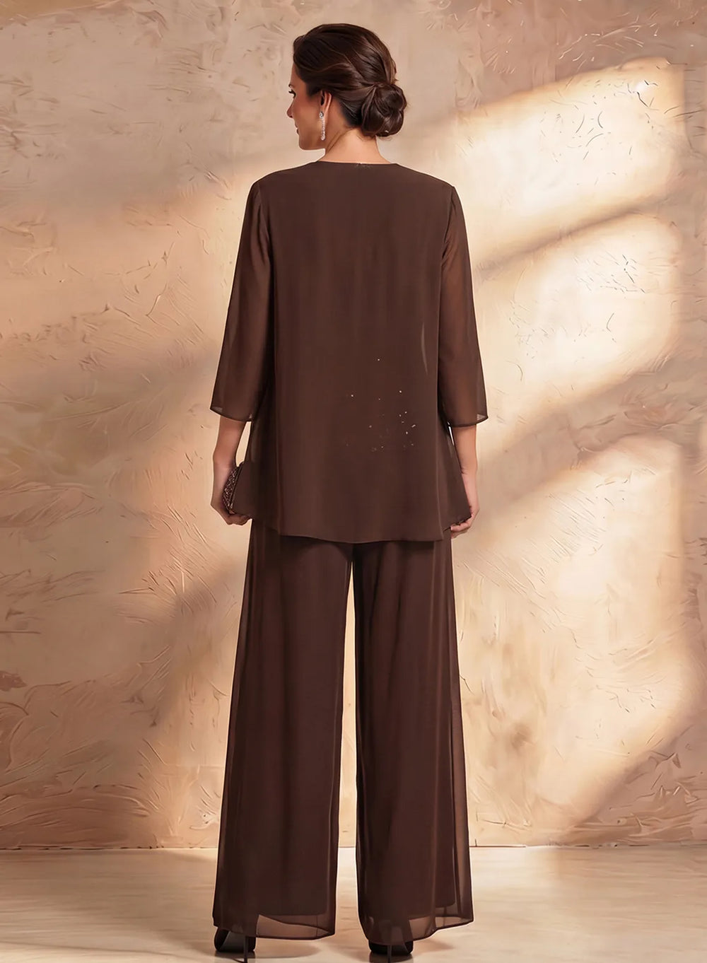 Back view of brown chiffon pantsuit with flowing jacket and wide leg formal pants