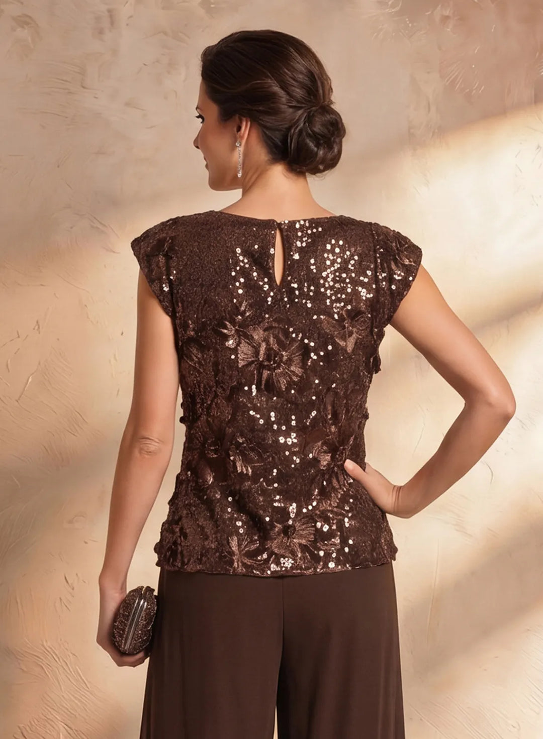 Back detail of brown lace formal top with delicate embroidery design