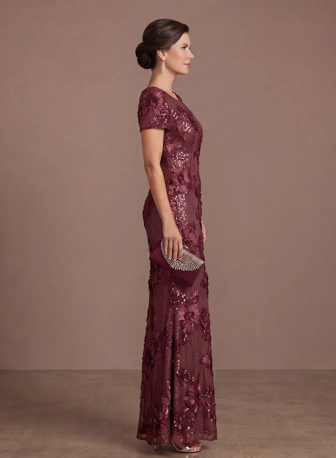 Side profile of a burgundy mermaid gown showcasing its fitted silhouette and flared hem