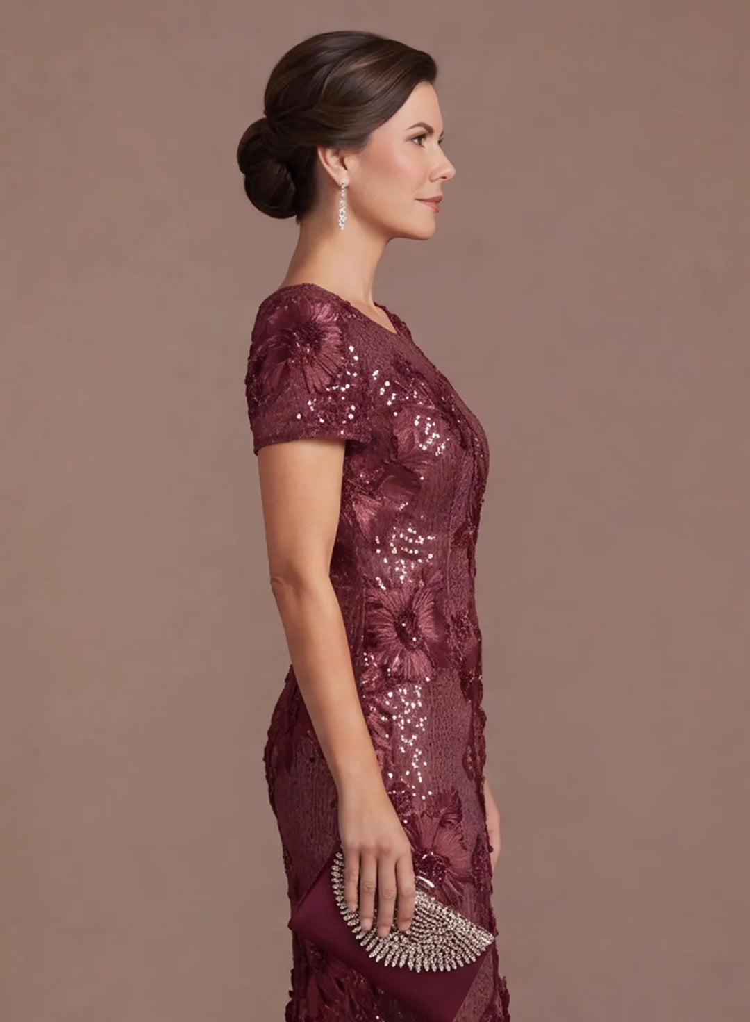 Side view highlighting the short sleeves and shimmering floral details of the burgundy gown