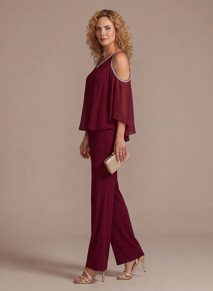 Side view of burgundy two piece formal pantsuit with straight leg trousers