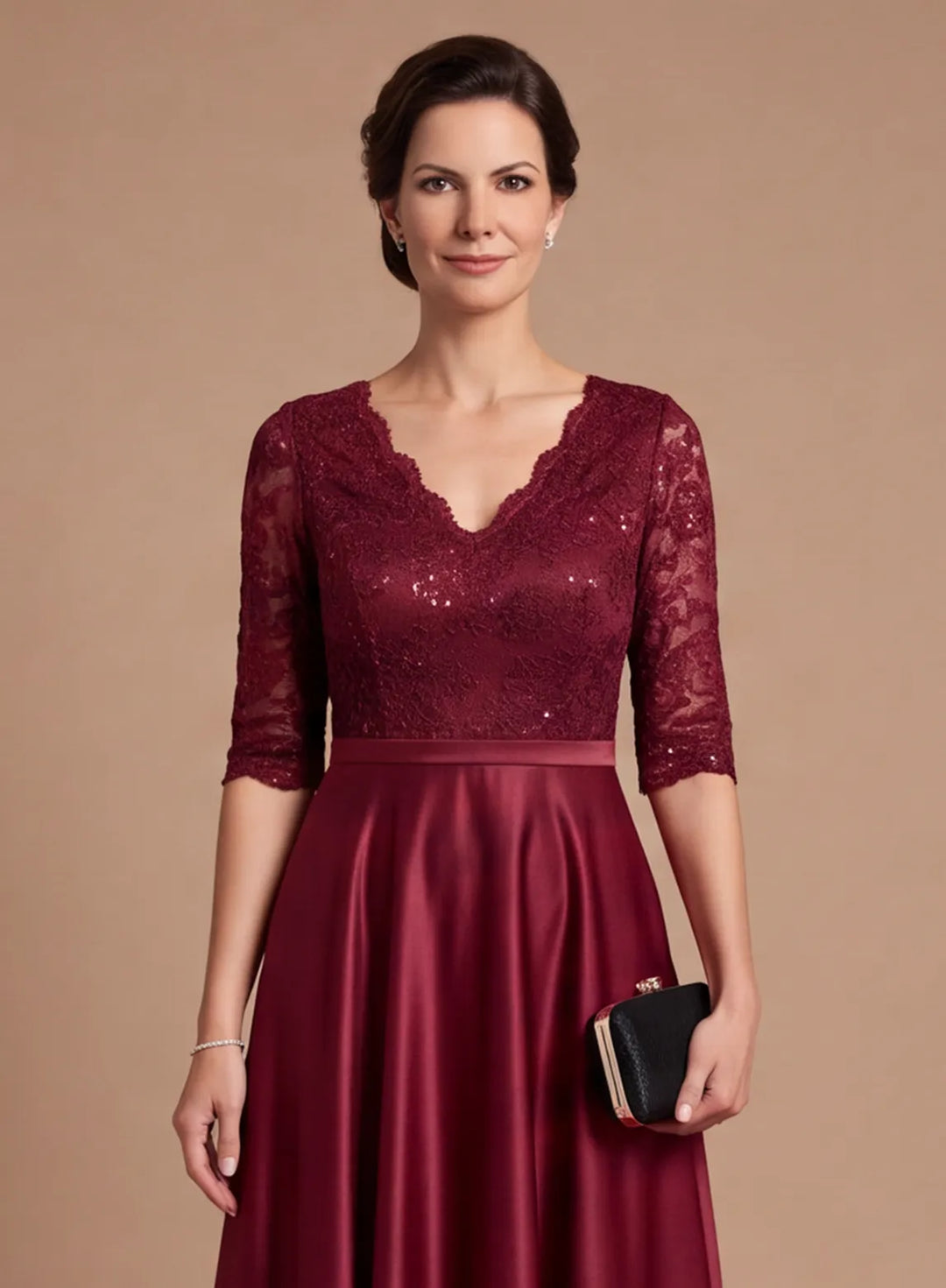 Close-up of burgundy lace bodice with V-neckline and 3/4 sleeves on a satin formal gown
