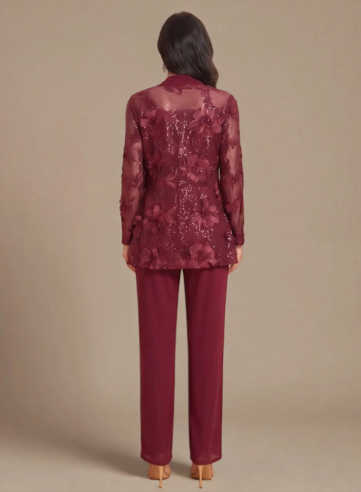Back view of a burgundy formal pantsuit featuring an elegant lace overlay jacket