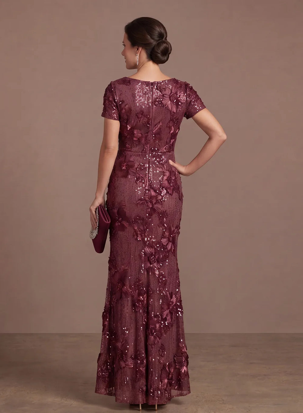 Back view of burgundy formal gown with floral sequin embellishments and zipper closure