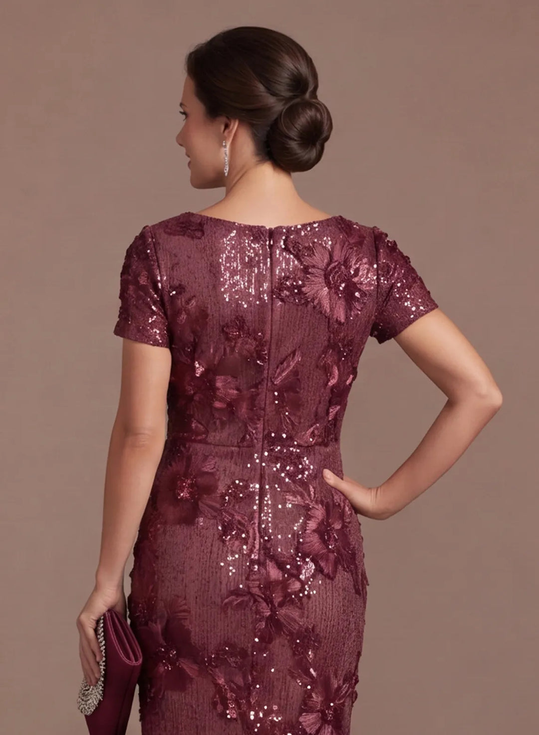 Back bodice detail of burgundy sequin dress with floral embellishments and short sleeves