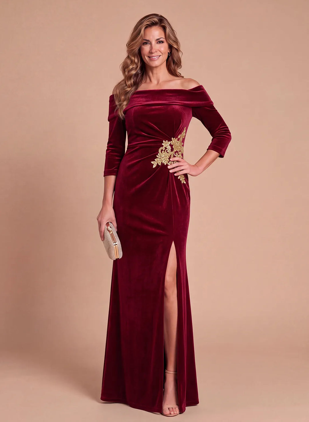 Burgundy velvet off-the-shoulder evening gown with gold floral appliqué and high slit, front view.