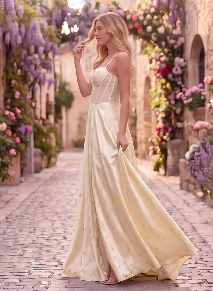 Side view of a butter yellow satin formal gown with polka dot details and a flowing floor-length skirt.