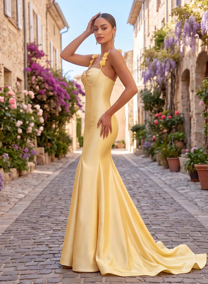 Side view of a butter yellow satin prom gown with fitted mermaid silhouette and flowing train.