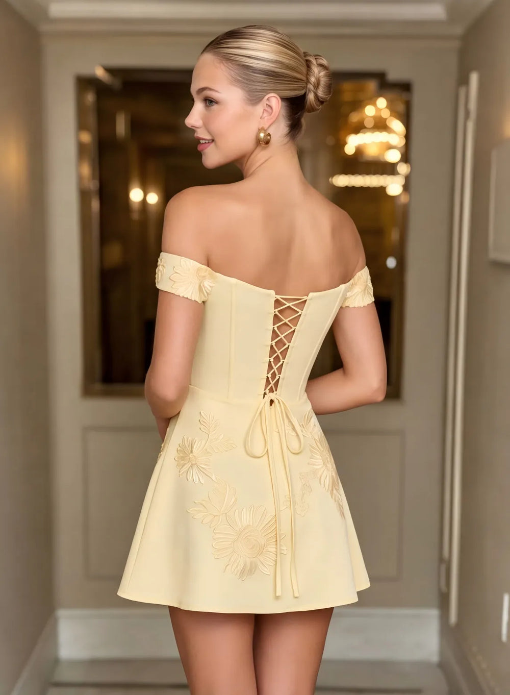 Champagne homecoming dress featuring an elegant lace up back and off shoulder design