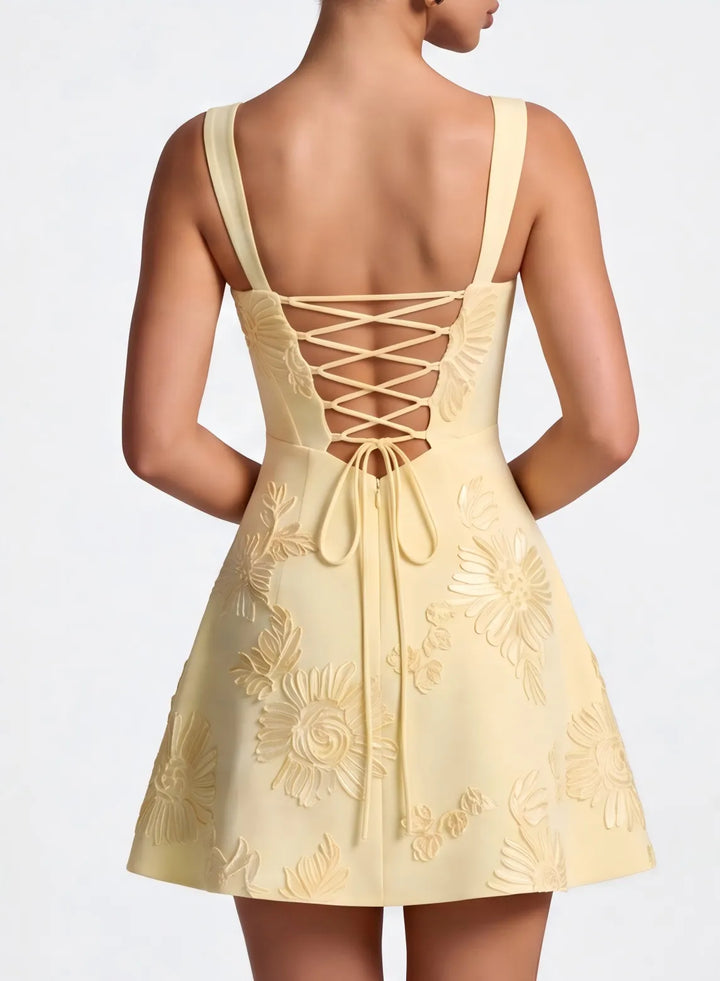 Champagne mini homecoming dress featuring a lace up open back and delicate thin straps