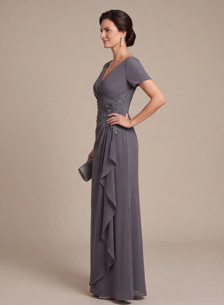 Side view of a charcoal gray formal gown with a ruched waist and flowing skirt