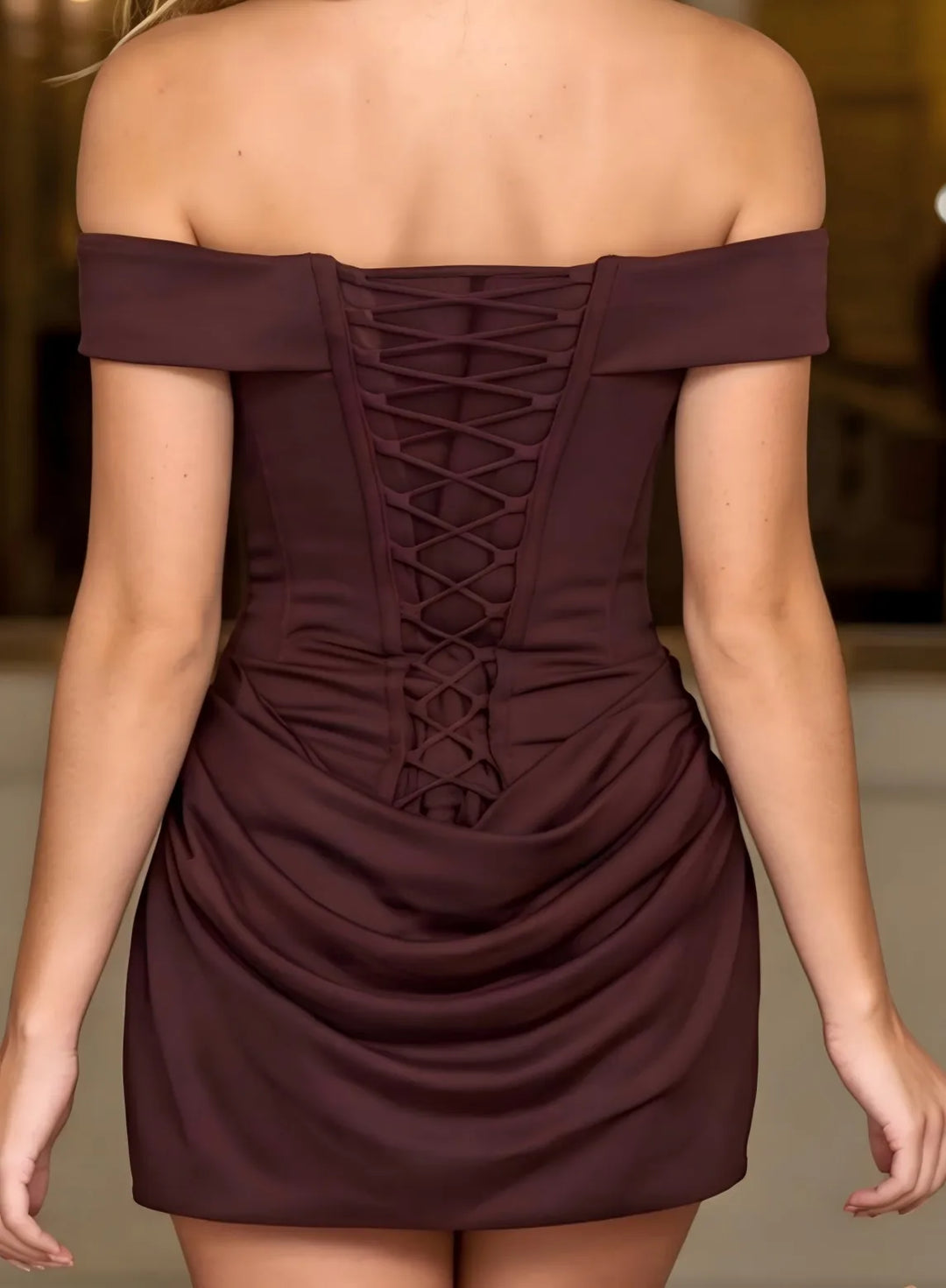 Back view of a coffee brown off shoulder mini dress with elegant ruched details