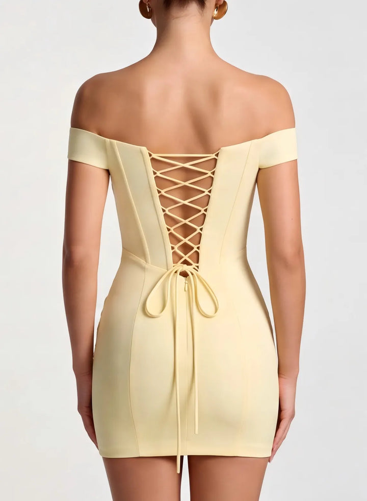 Close view of an off shoulder champagne formal dress with a stylish open back design