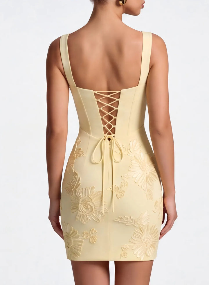 Cream open back mini dress with delicate straps and an elegant feminine design