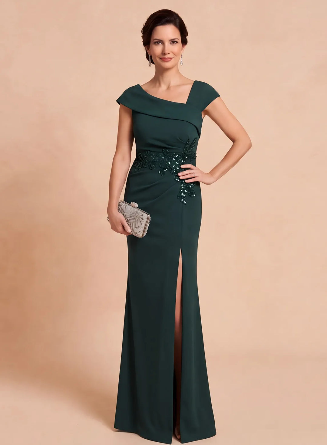Front view of a dark emerald formal gown with an asymmetrical neckline and front slit