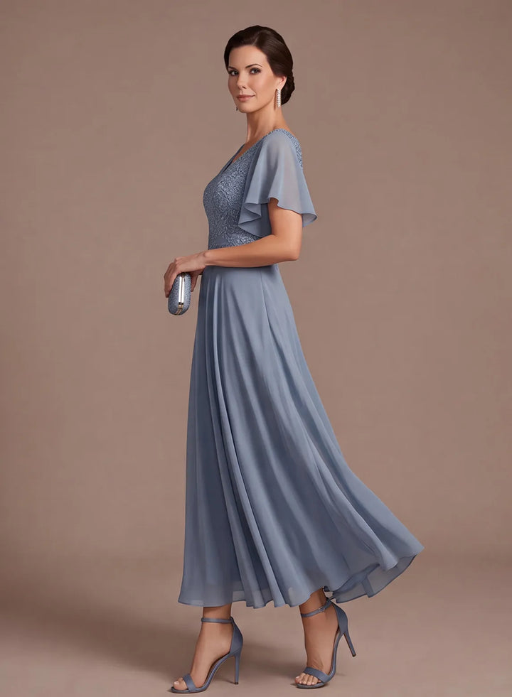 Side view of elegant dusty blue chiffon A-line wedding dress with flowing skirt