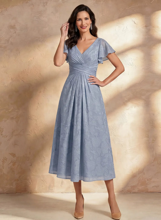 Elegant dusty blue mother of the bride dress with flutter sleeves and flattering A-line silhouette