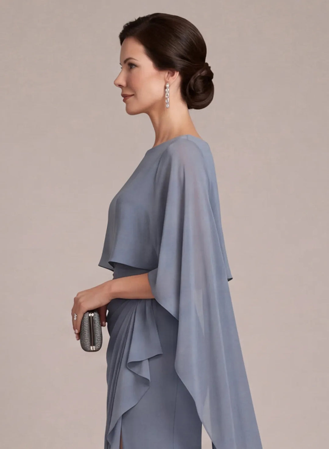 Side view of dusty blue mother of the bride dress with flowing cape sleeves and elegant silhouette