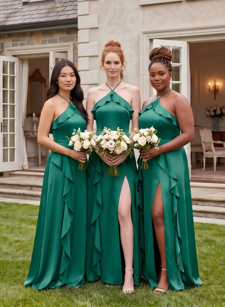 Group of bridesmaids in elegant emerald green satin dresses