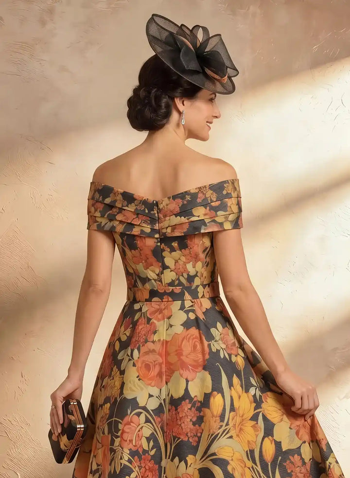 Back design of floral midi dress showing elegant off shoulder design and flattering waist detail