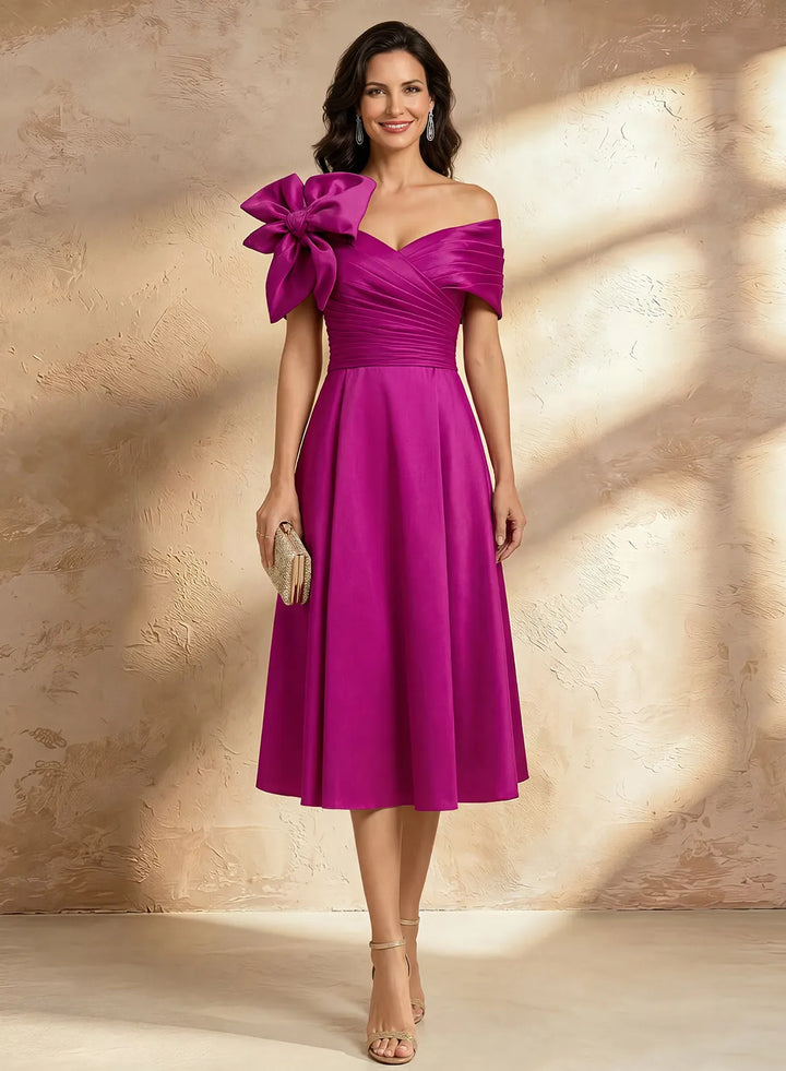 Fuchsia pink off shoulder midi dress with 3D floral bow detail and elegant A-line silhouette