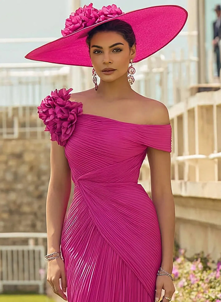 Fuchsia pink formal dress featuring a 3D floral shoulder detail and elegant draped design