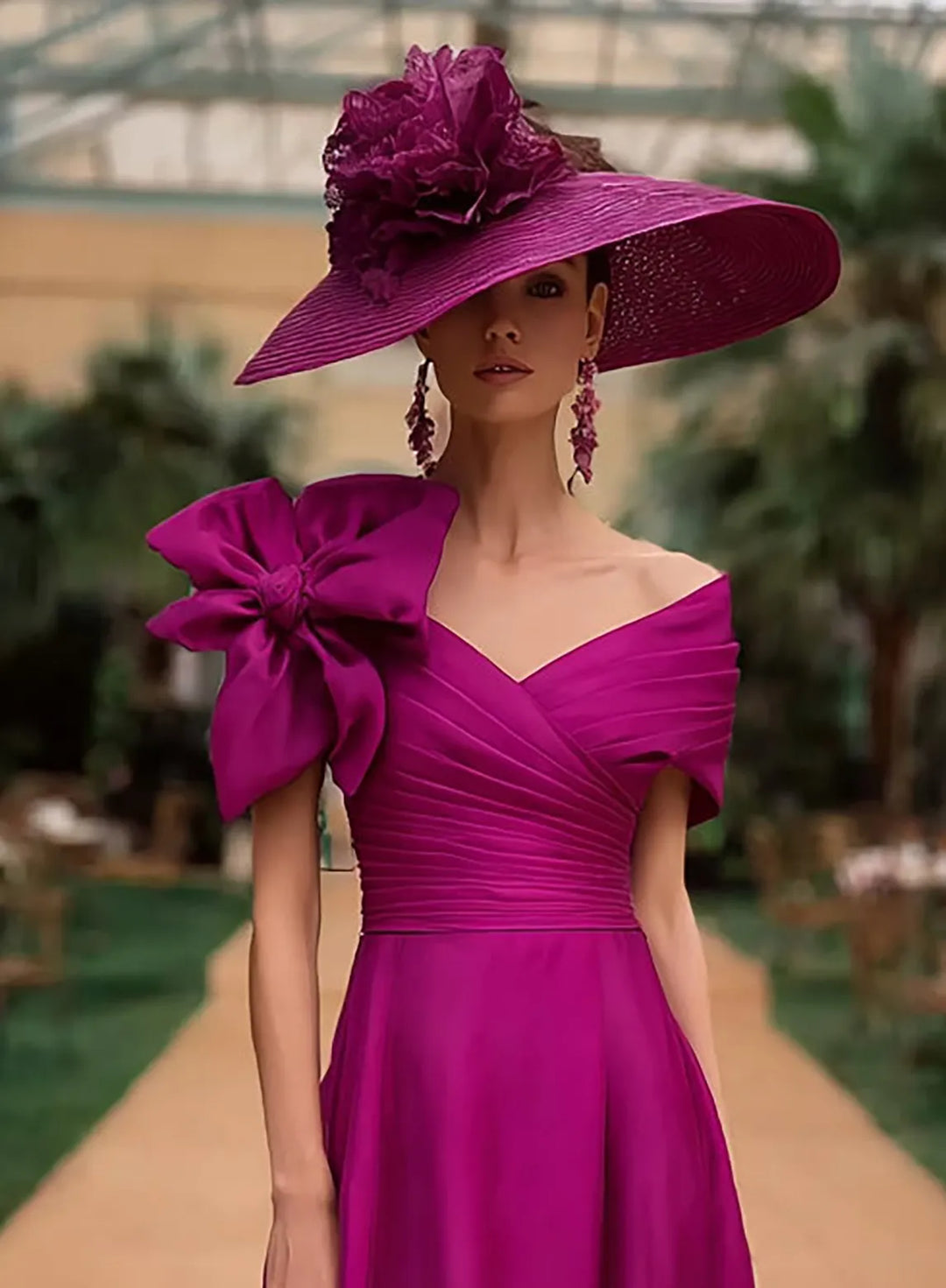 Fuchsia pink mother of the bride dress with an elegant off shoulder neckline and classic style