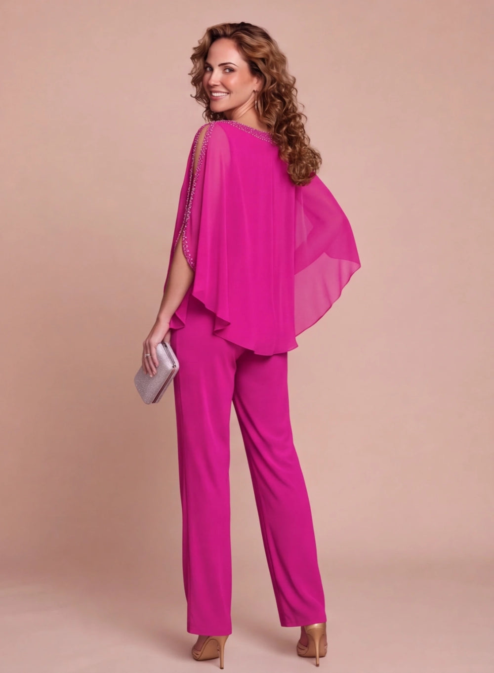 Back view of fuchsia two piece pantsuit with chiffon cape overlay