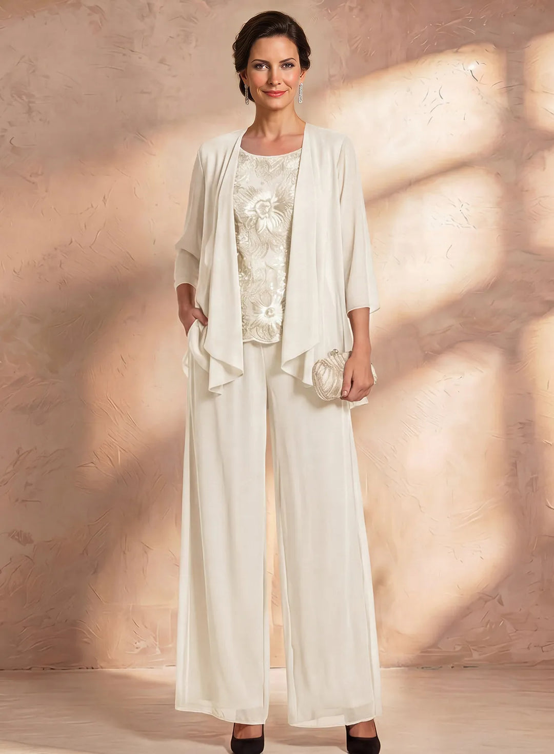 Ivory mother of the bride pantsuit with embroidered lace top and lightweight formal jacket