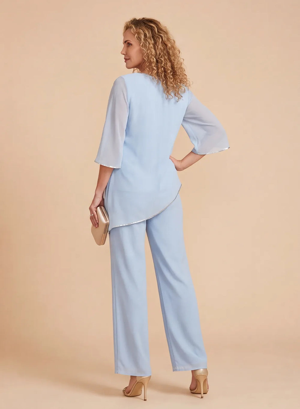 Back view of a light blue chiffon pantsuit with an asymmetric hem top and matching straight-leg pants