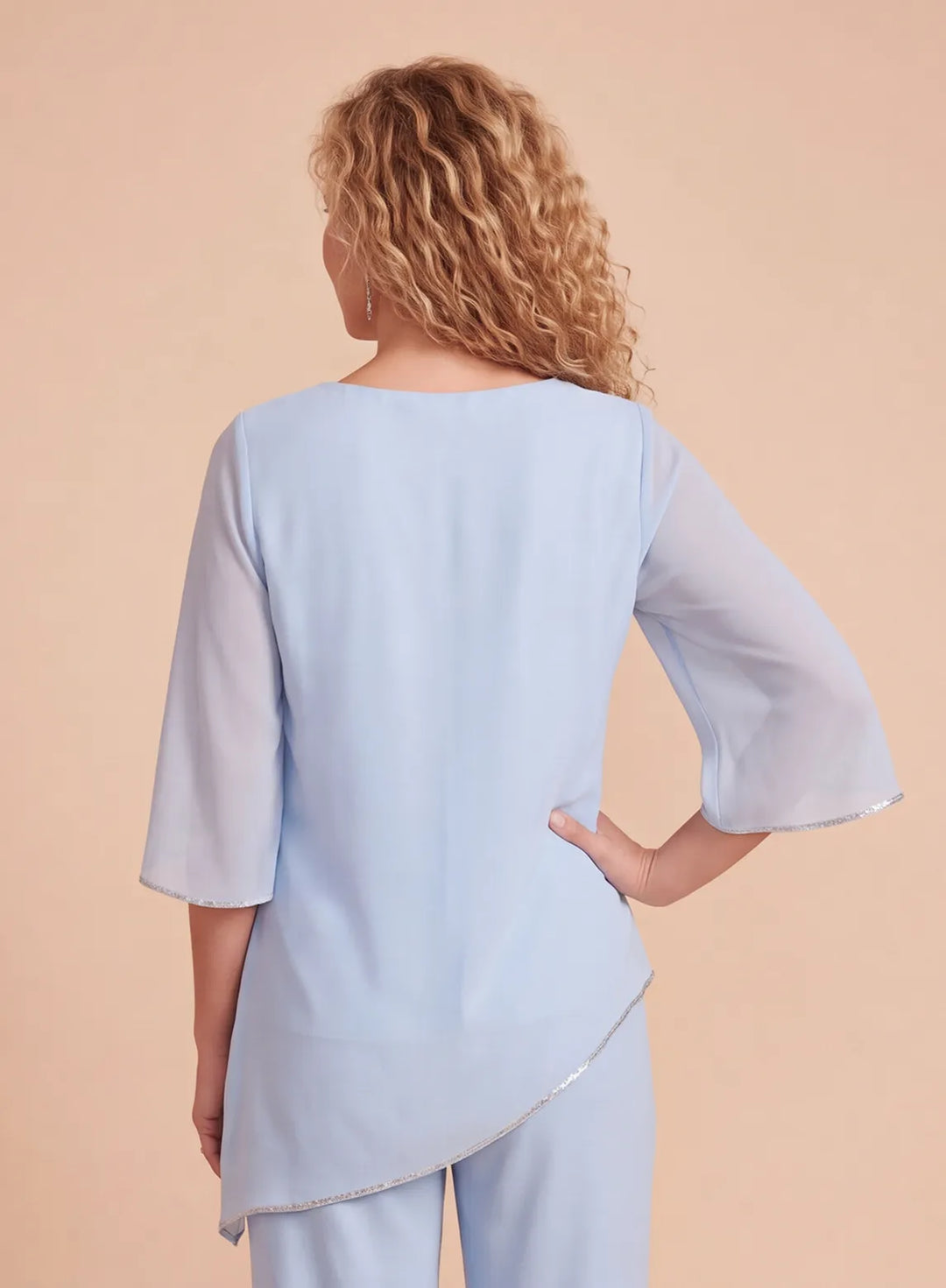 Back detail of a light blue chiffon pantsuit top with a flowing silhouette and elegant asymmetric hem