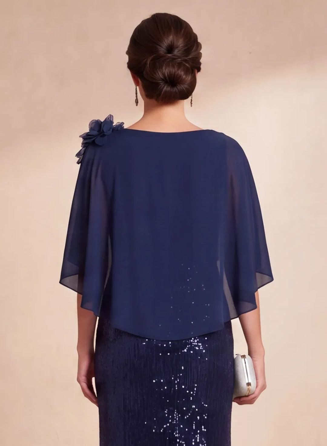 Back detail of navy blue chiffon cape overlay on sequin formal gown