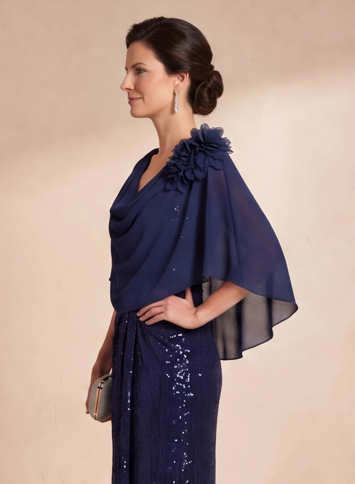 Side detail of flowing chiffon cape and navy blue sequin dress
