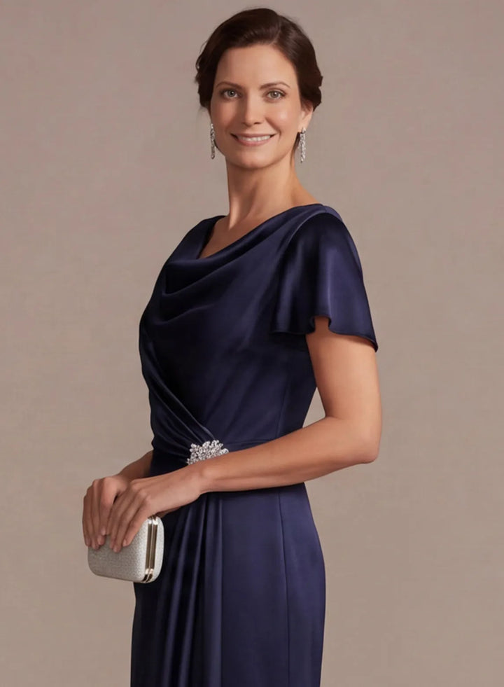Navy blue formal gown with sparkling beaded waist detail and elegant satin finish