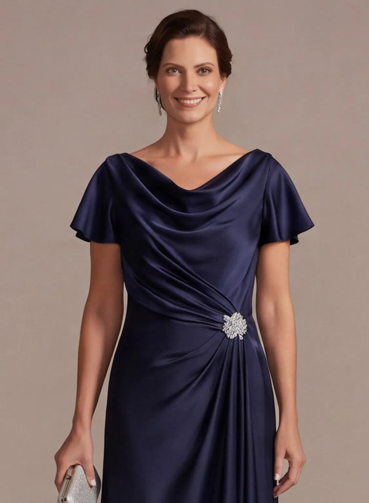 Close up detail of navy satin dress with draped cowl neckline and soft fabric texture