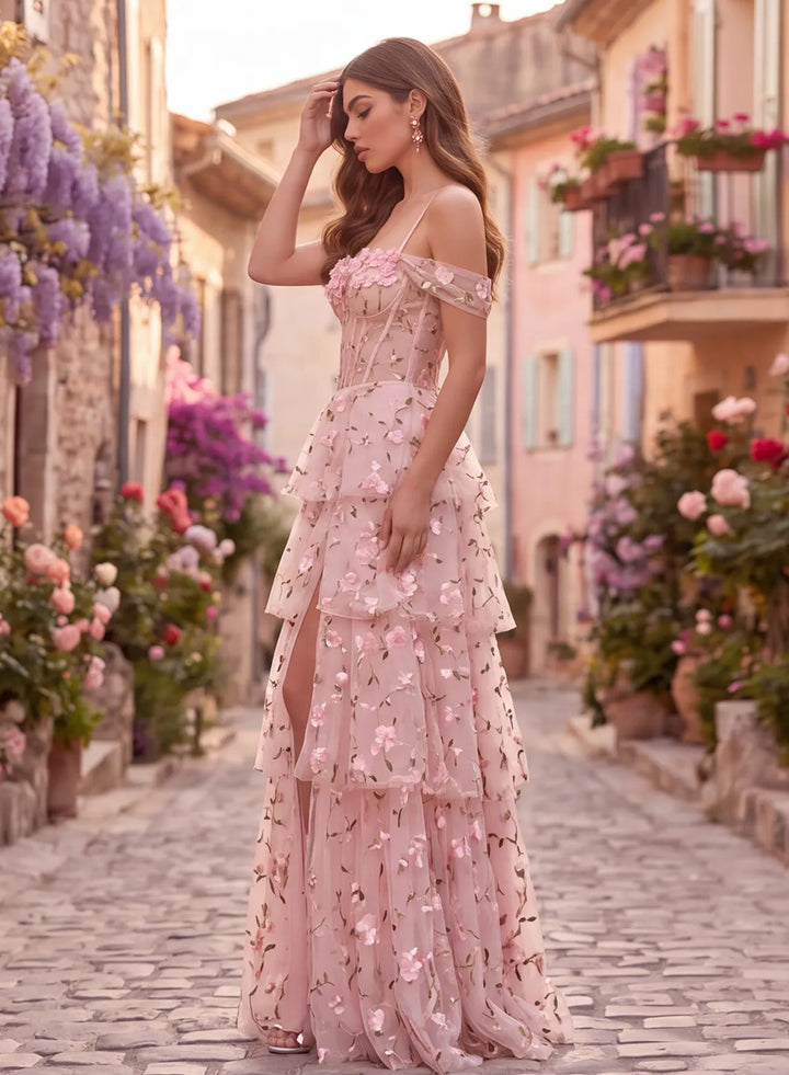 Side view of pink floral lace prom dress with off-shoulder neckline and tiered skirt