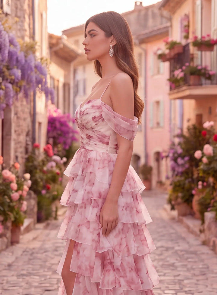 Three-quarter view of pink organza prom dress with spaghetti straps and flowing ruffles