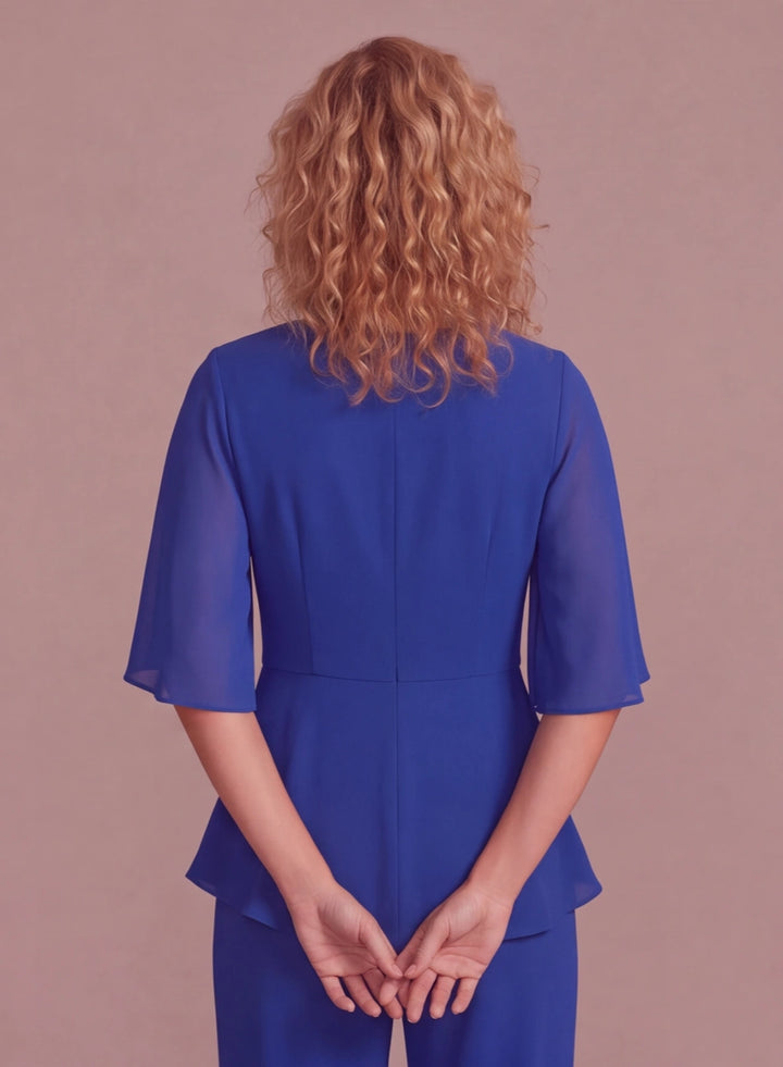 Back detail of elegant royal blue chiffon pantsuit with flowing sleeves and tailored waist