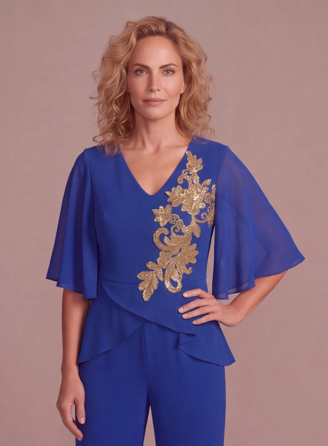 Close-up of gold floral embroidery on a royal blue chiffon pantsuit