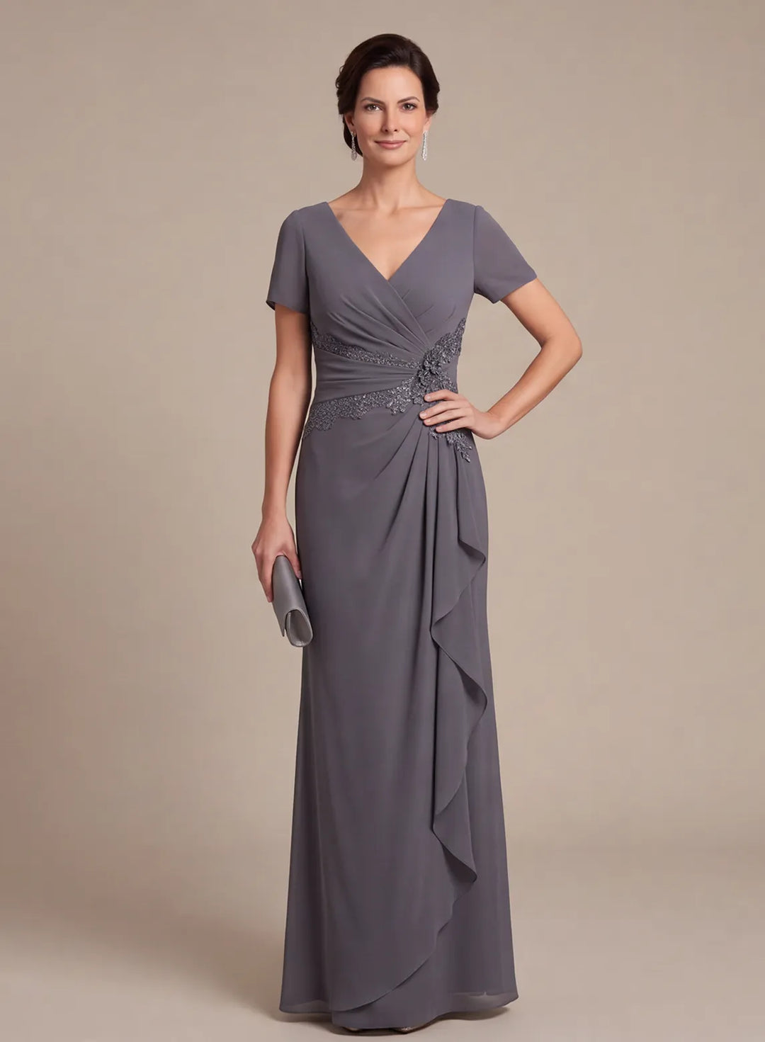 Front view of a slate gray V-neck formal gown with short sleeves and a cascading ruffle