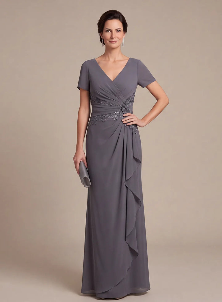 Front view of a slate gray V-neck formal gown with short sleeves and a cascading ruffle