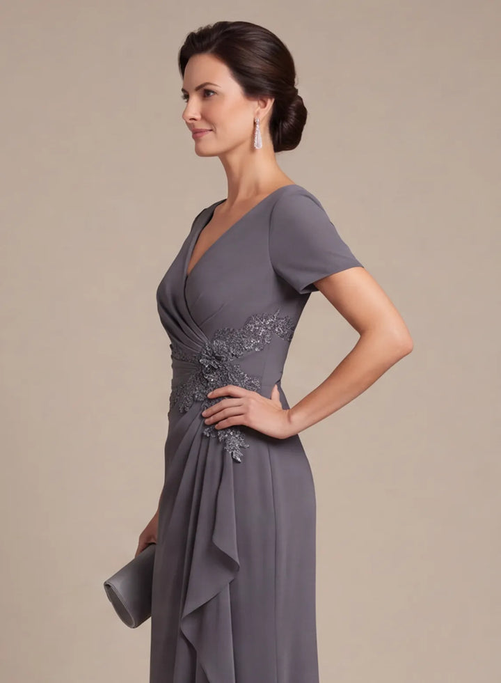 Slate gray gown featuring a cascading front ruffle and gathered waist