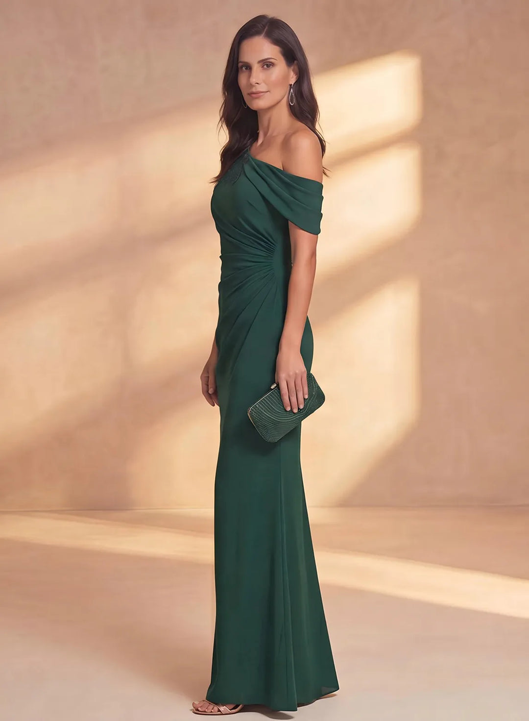 Side profile of emerald chiffon mother of the bride gown with fitted silhouette