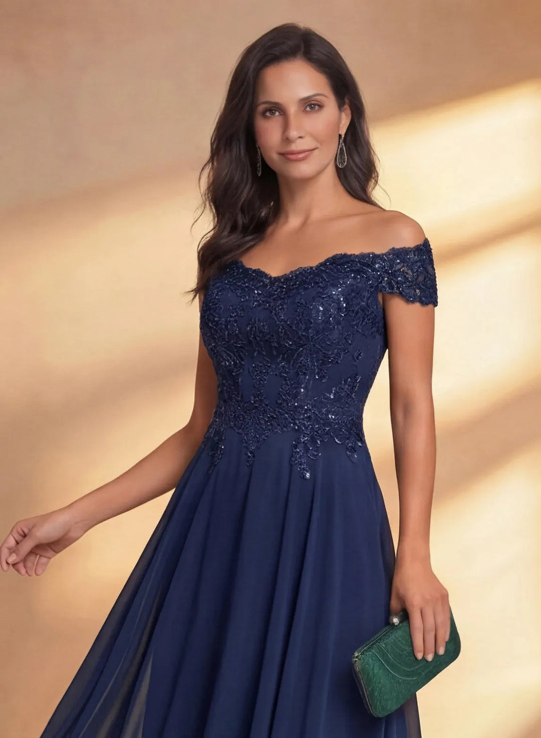 Close-up of the off shoulder neckline and fitted bodice on a navy formal midi dress